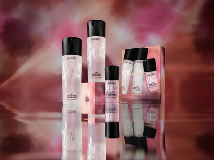 ピンクの背景に透明のボトルの化粧水が並んだ画像