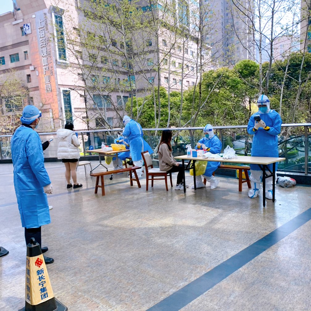 防護服に身を包むスタッフらによる屋外でのPCR検査の様子