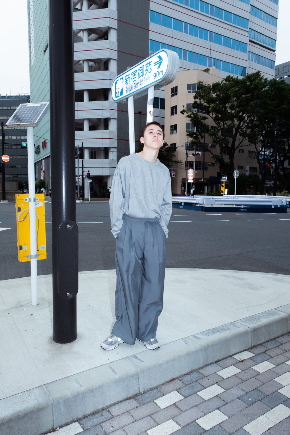 グレーのTシャツにグレーのパンツを着用した男性モデル