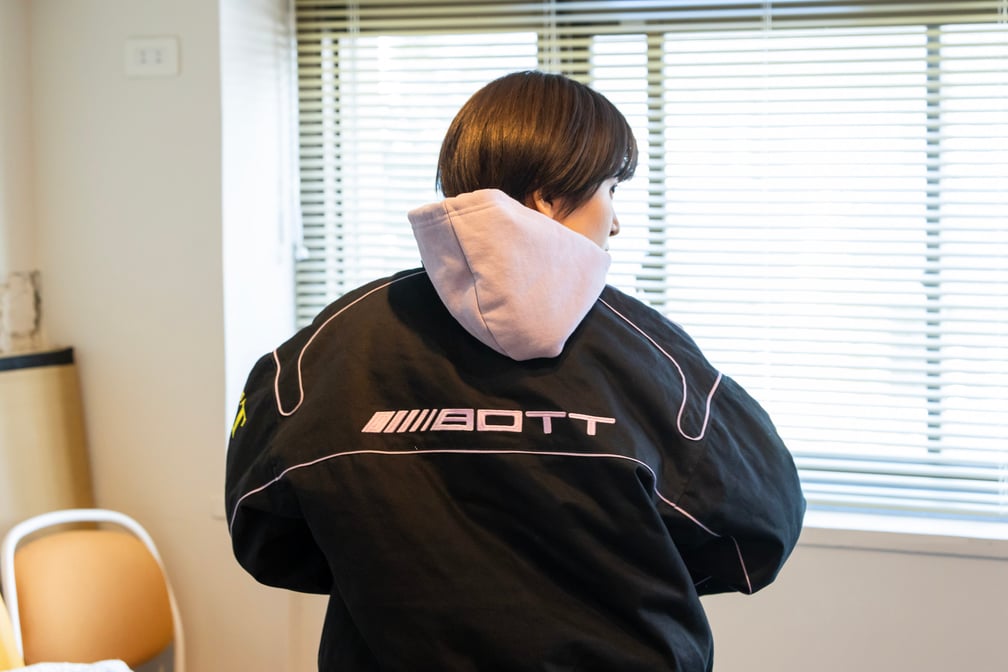 黒いジャケットを着用するサーヤの後ろ姿