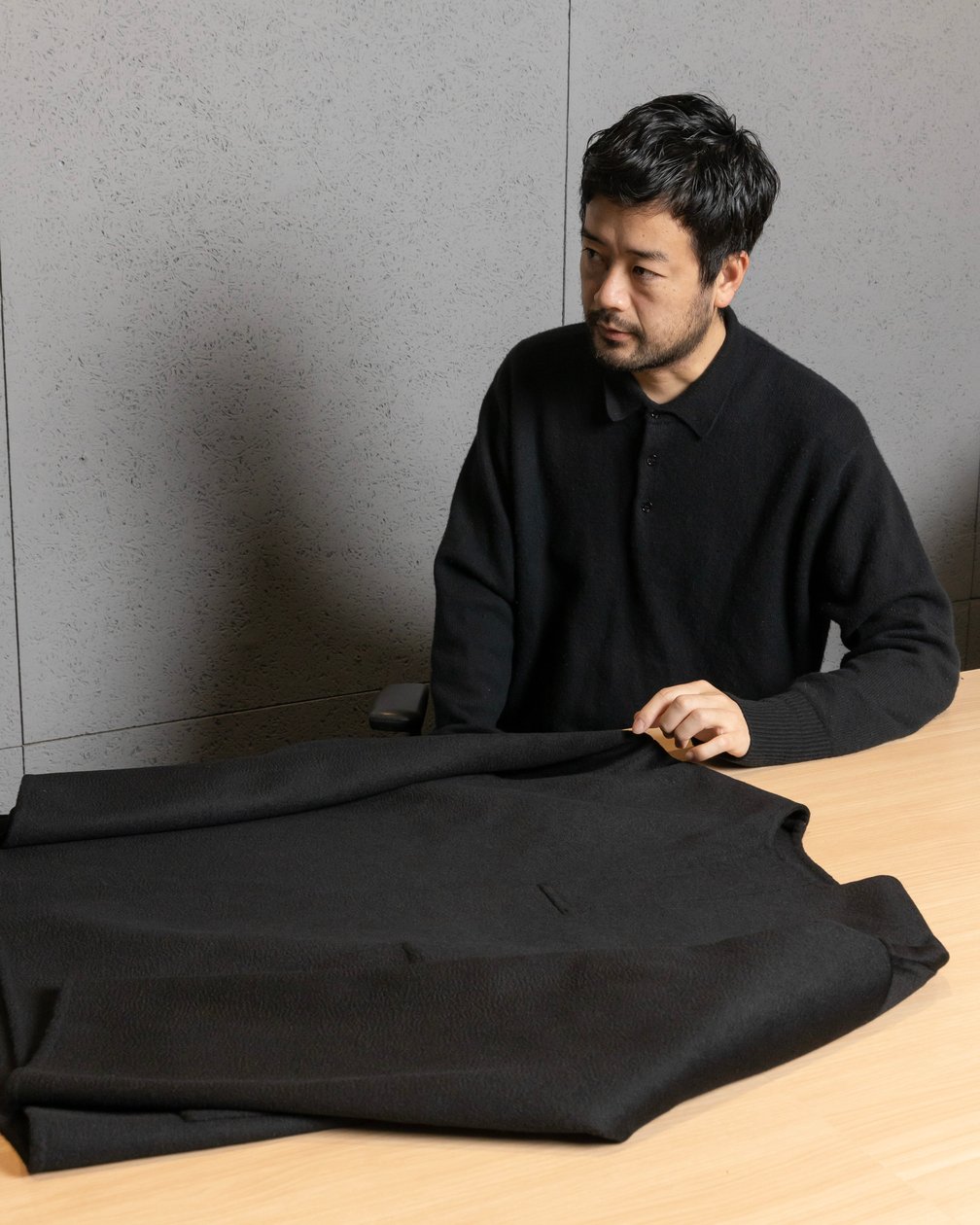 椅子に座ってインタビューを受ける男性