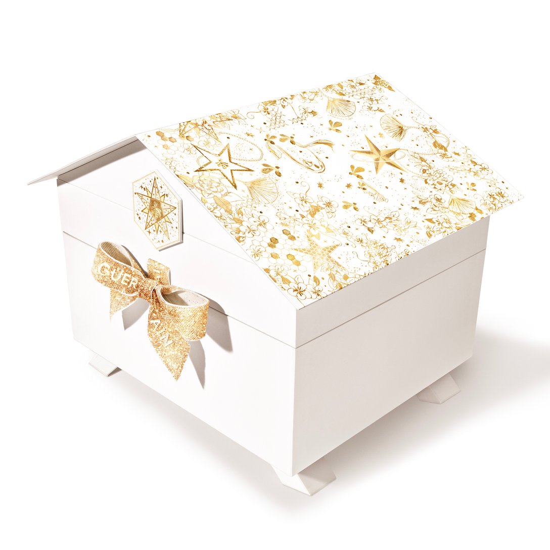 ミツバチ箱のような形状の白いリボンが付いたパッケージ