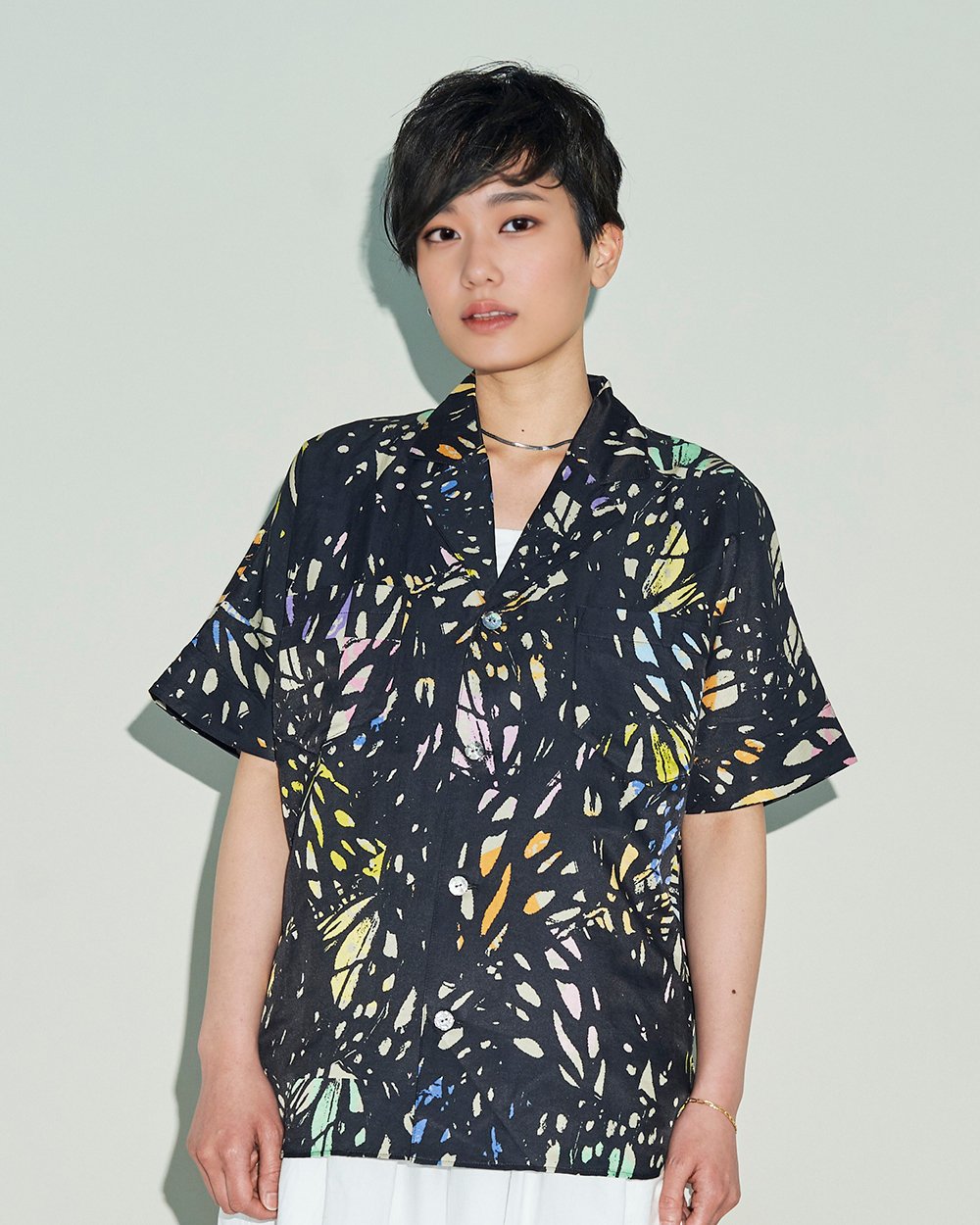 TANAKAのプリントシャツを着た女性