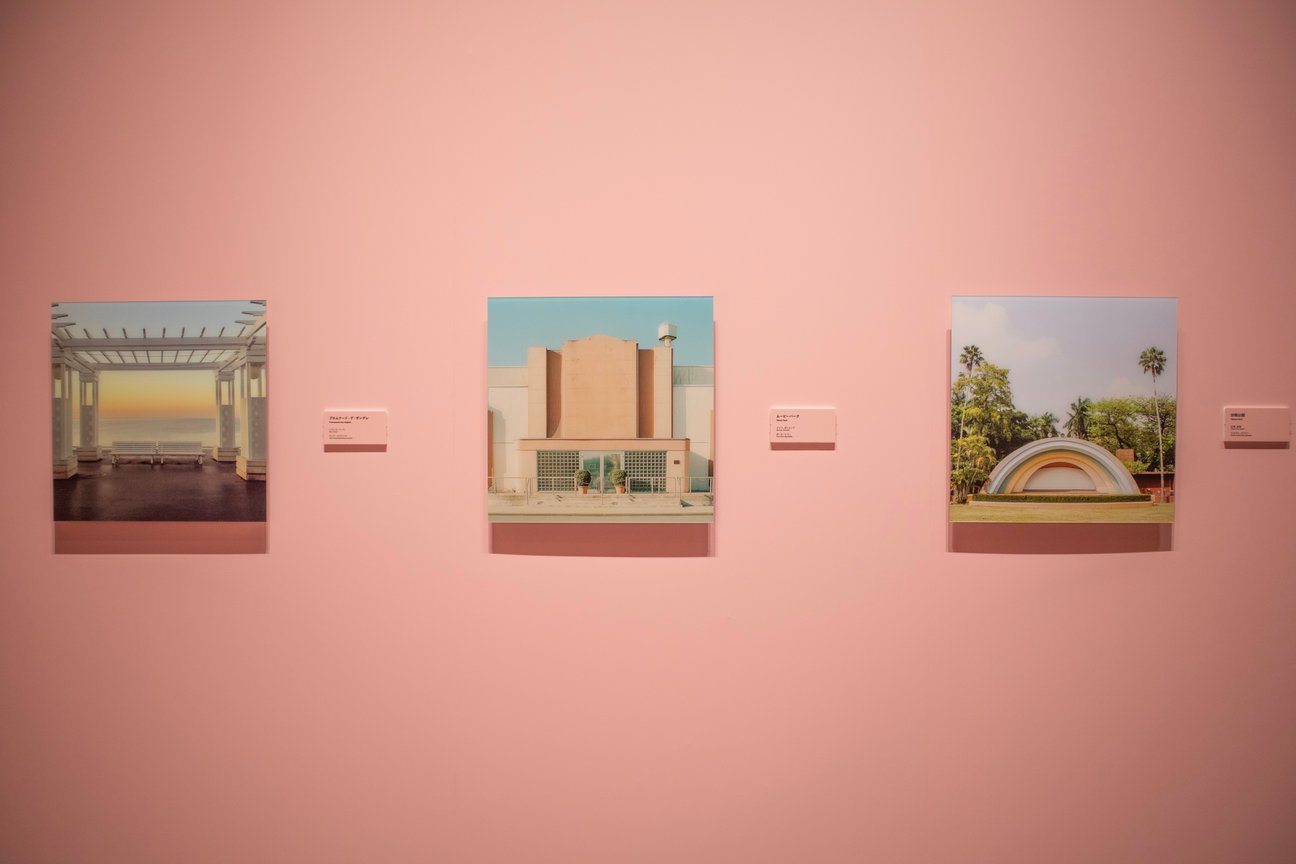 ピンクの壁にかけられた写真作品