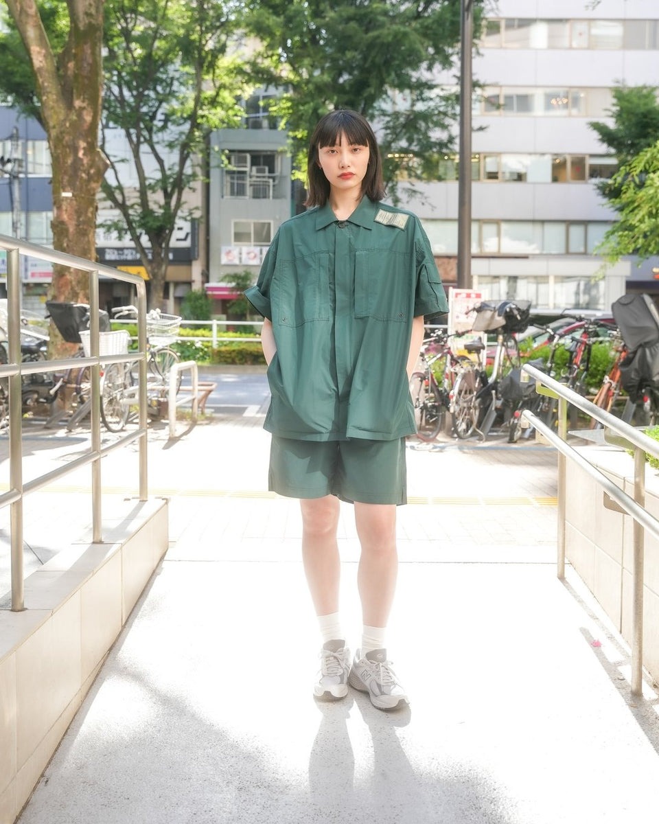 ミリタリーのセットアップを着用した女性モデル