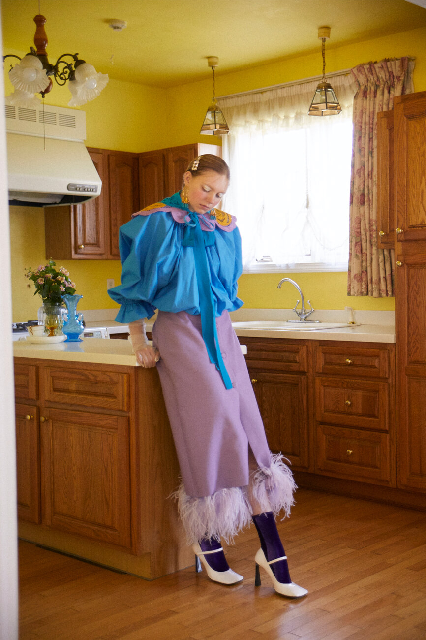 top, skirt, shoes, earrings and collar by PATOU　IZA , socks by SIMONE WILD　FILG SHOWROOM, hair clip by ROGER VIVIER　ROGER VIVIER JAPAN, gloves stylist’s own