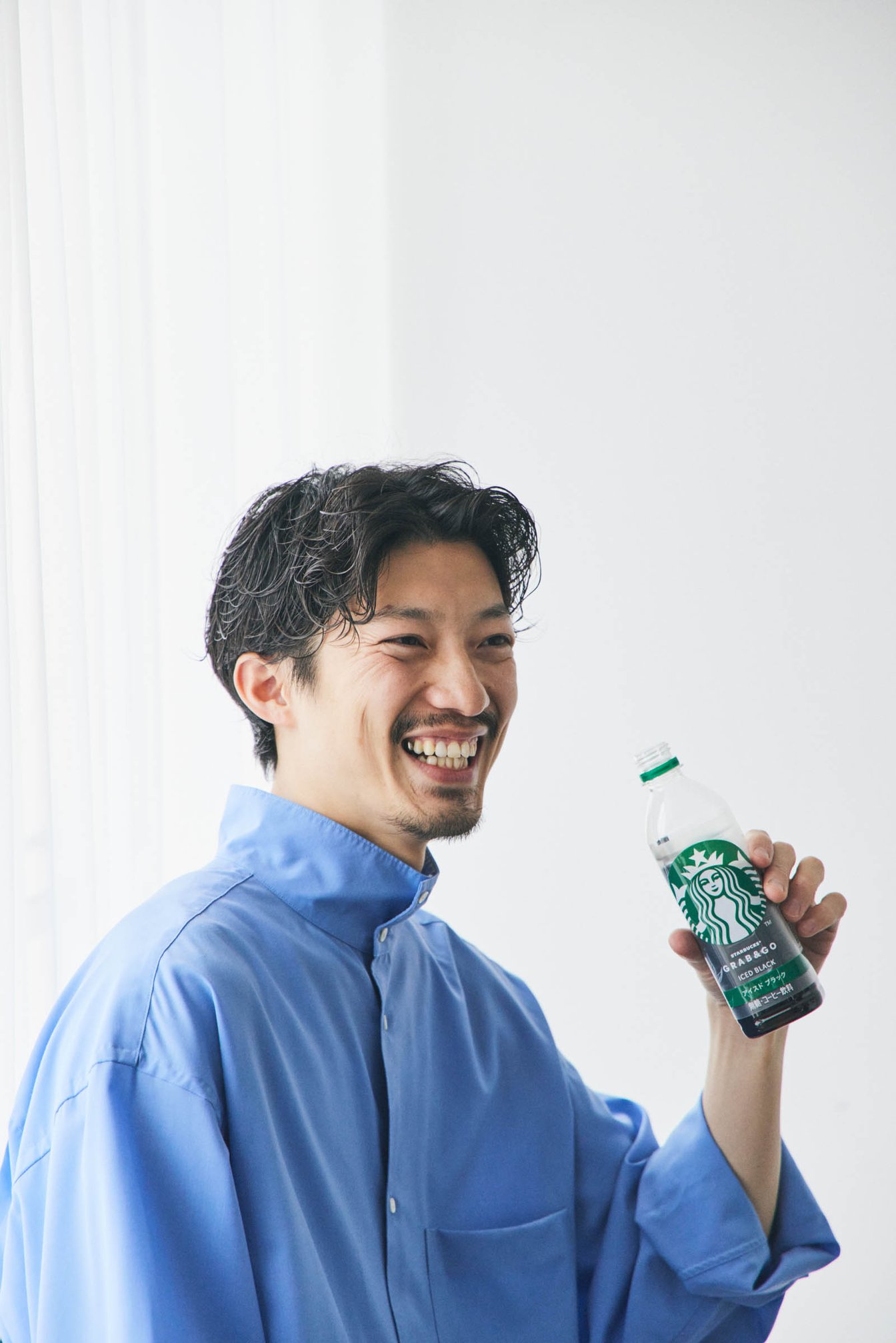 スターバックスのボトルと男性