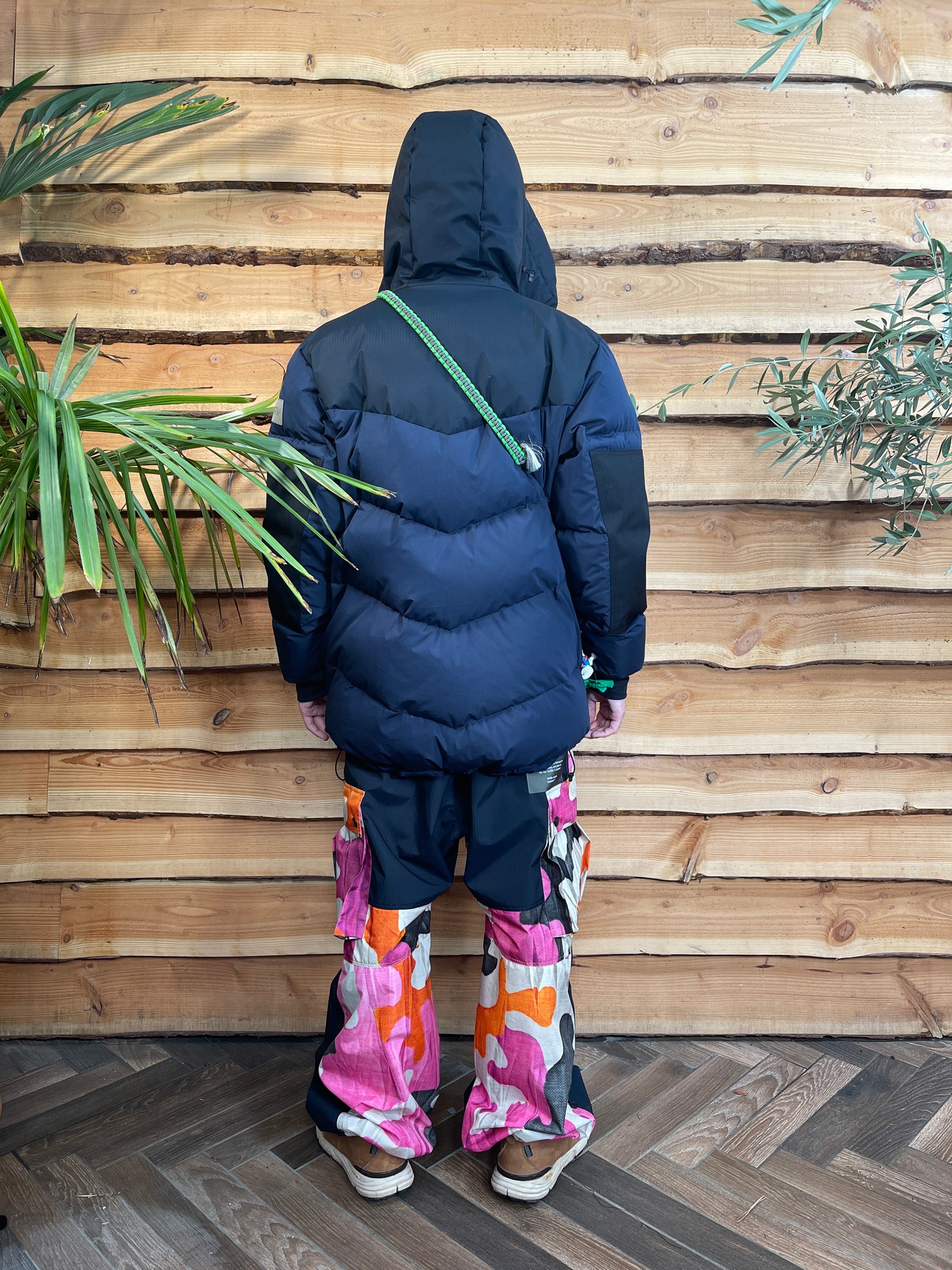 黒いボムジャケットを着て後ろを向いて立つ人