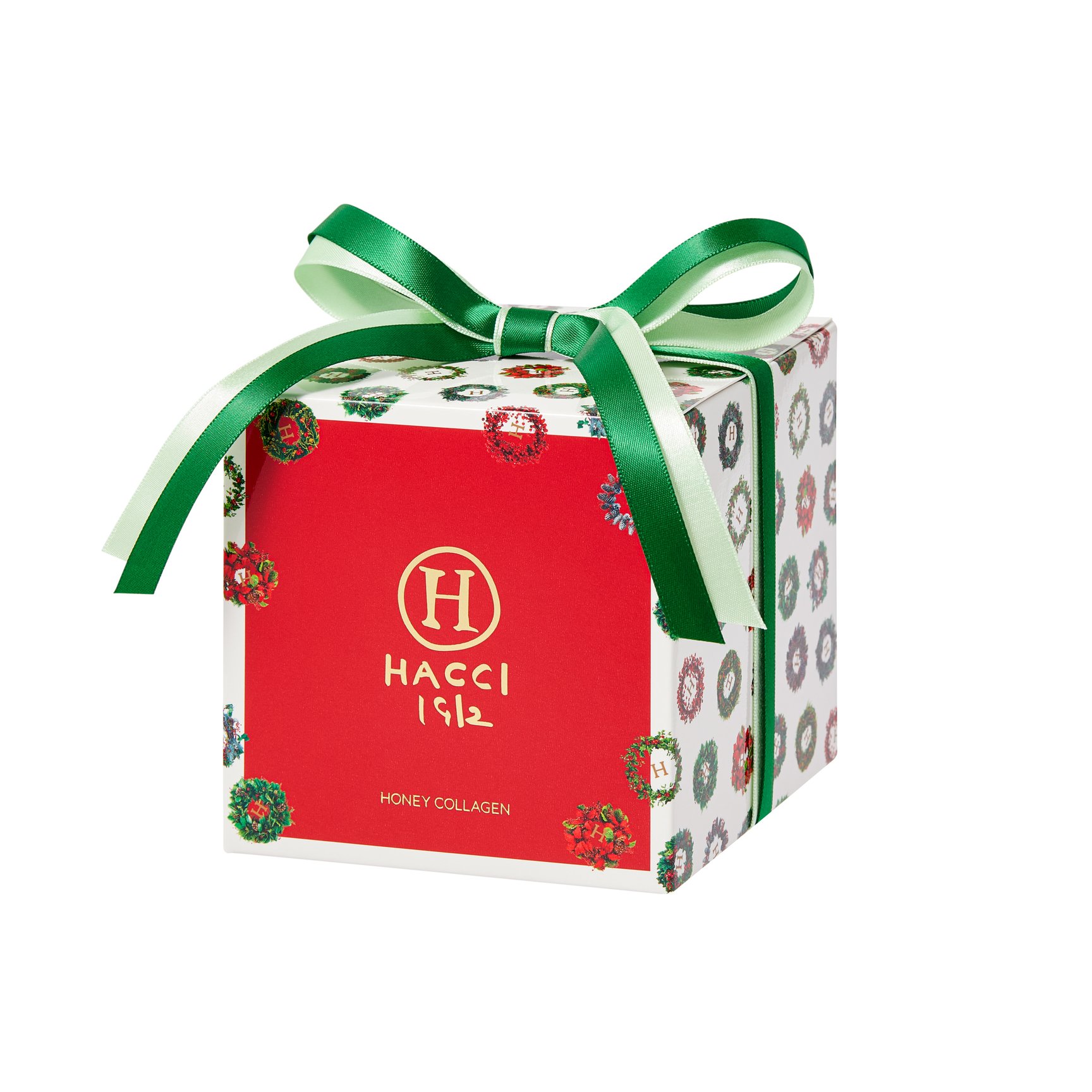 緑のリボンが結ばれたクリスマス模様のギフトボックス