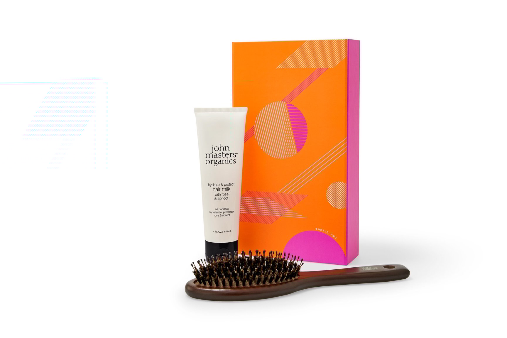 オレンジの外箱と白いチューブのヘアミルク、ブラウンのヘアブラシ
