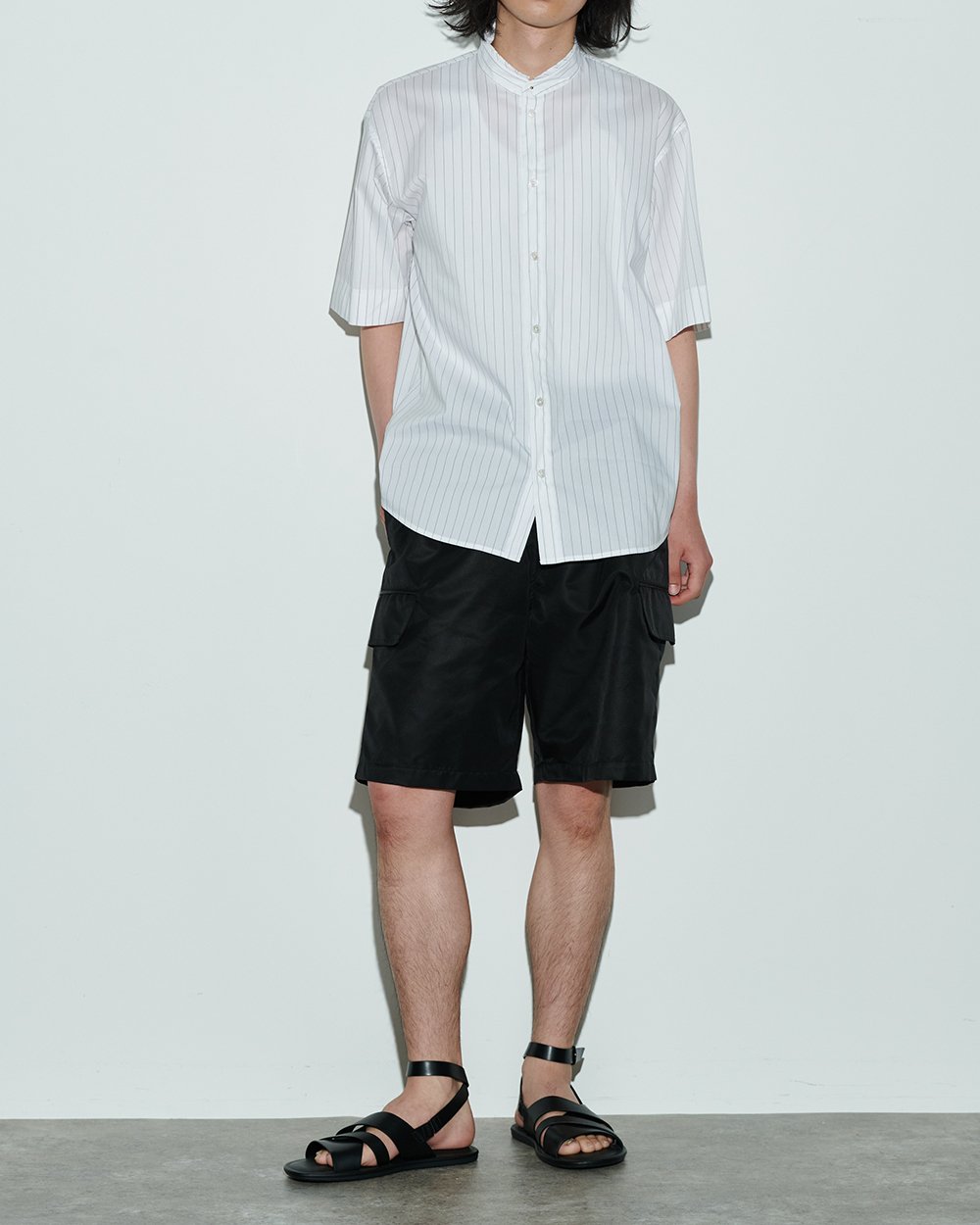 ホワイトストライプのシャツを着用した男性モデル