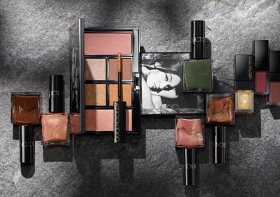 無機質な背景に無数のコスメが並べられている様子