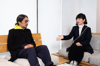 話をする黒い服を着た男性と女性