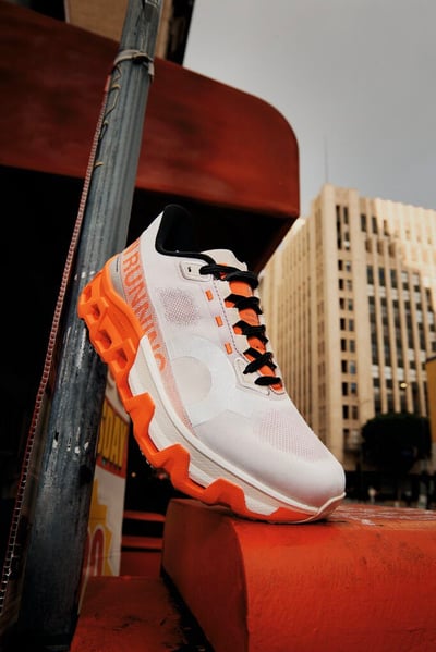 白とオレンジを配したトレーニングシューズ